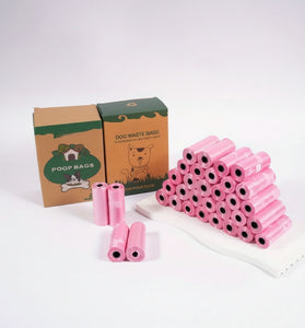 Pink rolls of dog waste bags with cardboard boxes on a white background