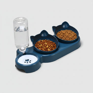 Pet feeding station with two bowls of food and a glass of water on an orange background
