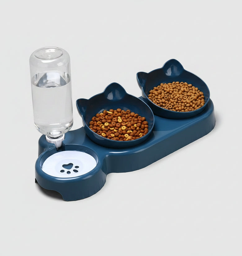 Pet feeding station with two bowls of food and a glass of water on an orange background