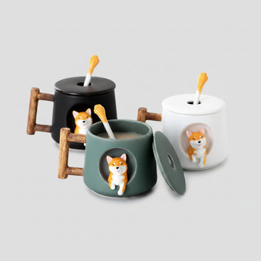 Set of ceramic mugs with dog designs on a table