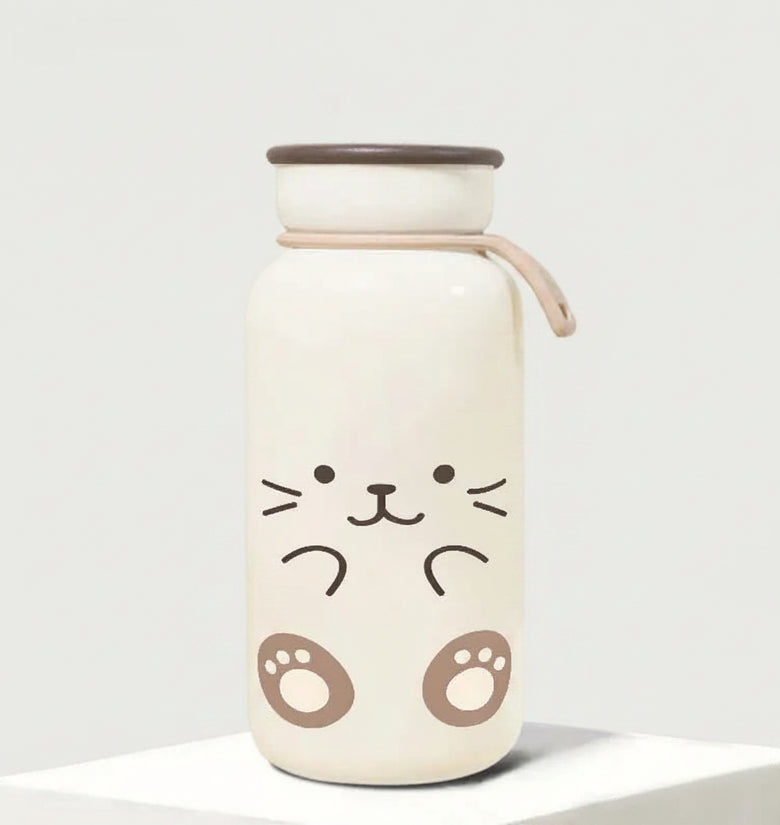 Cute water bottle with cat face design on a plain background