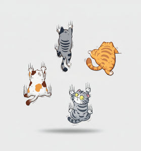 Wall stickers of cartoon cats on a wall in a room with a child's play area.