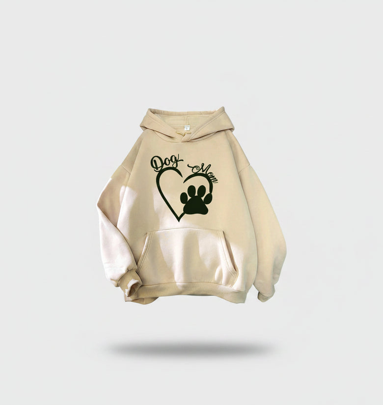 Beige hoodie with 'Dog Mom' and paw print design on a textured surface.