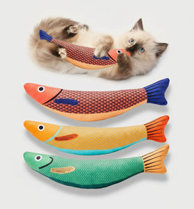 Three fish-shaped cat toys with a cat playing with one of them on a white background.