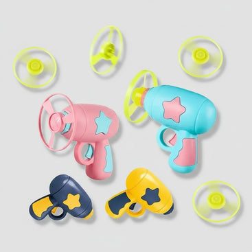 A set of colorful toy toy blasters and propeller attachments on a light gray background. The set includes three main blasters in pink, light blue, and yellow, each decorated with star-shaped cutouts, along with four separate propeller parts in neon yellow-green.