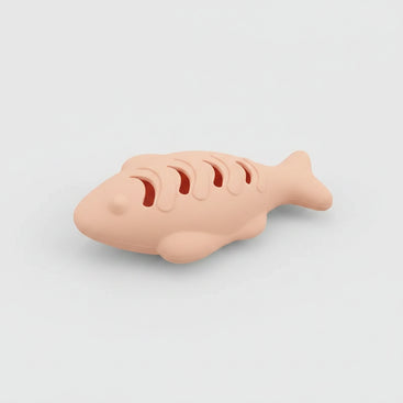 Cat playing with a silicone toy shaped like a fish, with text on both sides.
