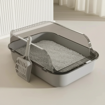Cat litter box with dimensions and a scoop on a light background