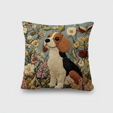 Decorative pillow with embroidered dog and floral design on a bed.