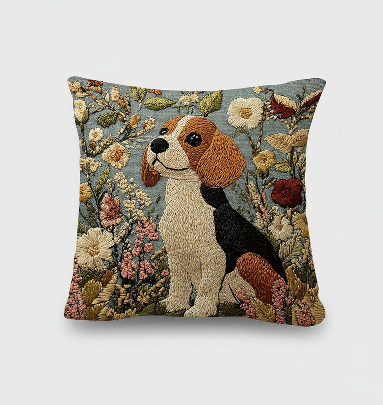 Decorative pillow with embroidered dog and floral design on a bed.