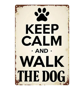 Vintage-style metal sign with paw print and text 'Keep Calm and Walk the Dog' on a white background.